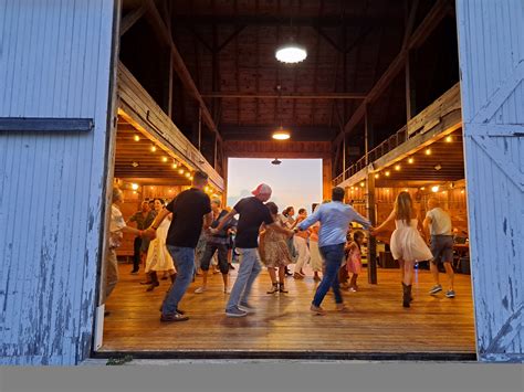Friends dancing in the barn at dusk